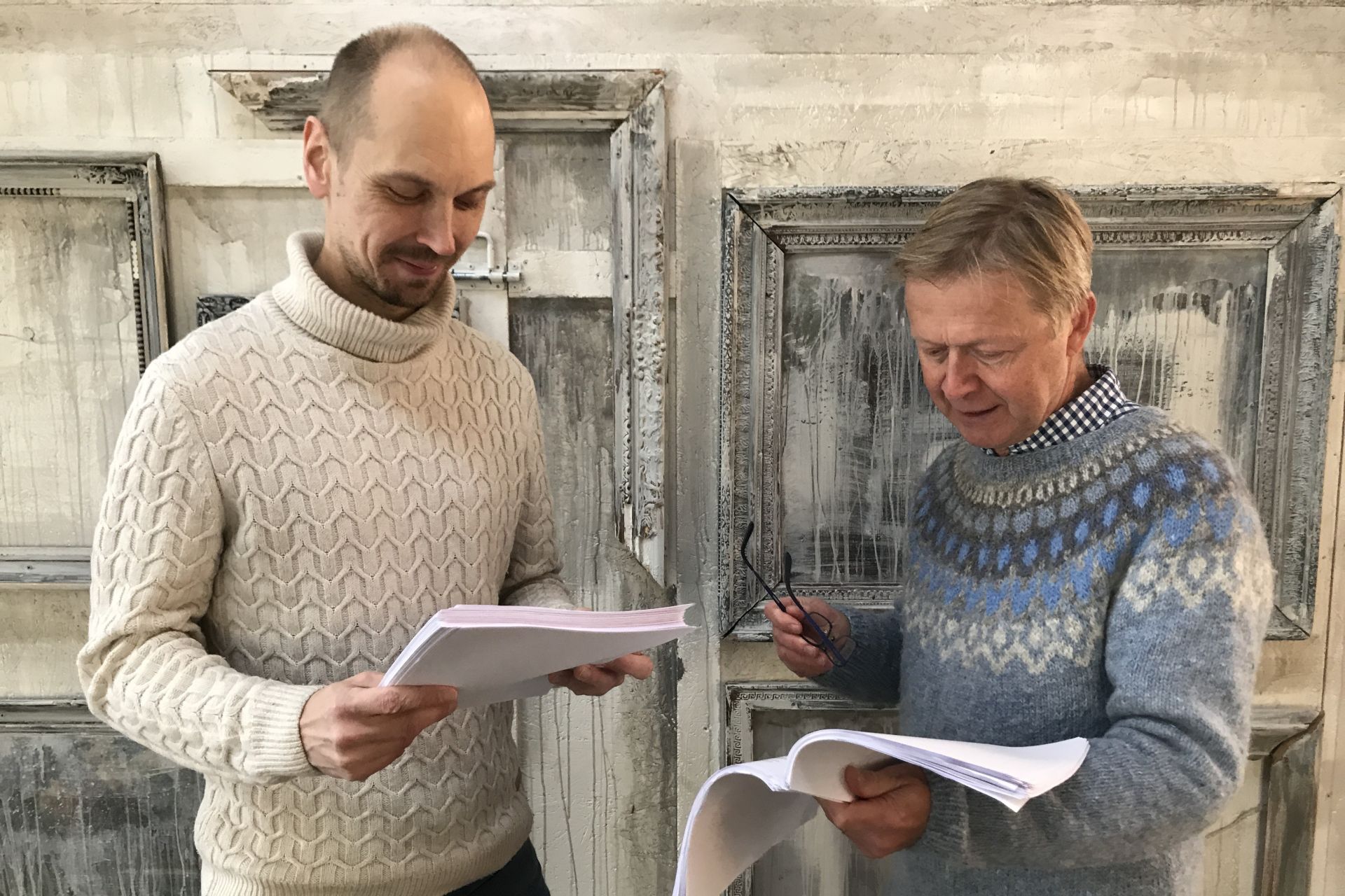 two men reading script